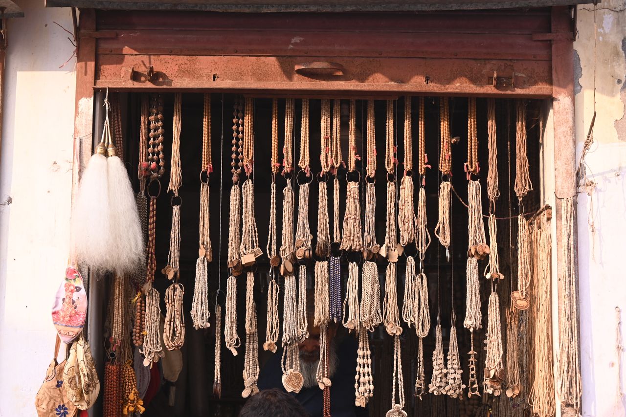 A display of handcrafted beads and necklaces at a traditional market stall, showcasing artisanal craftsmanship and cultural heritage.